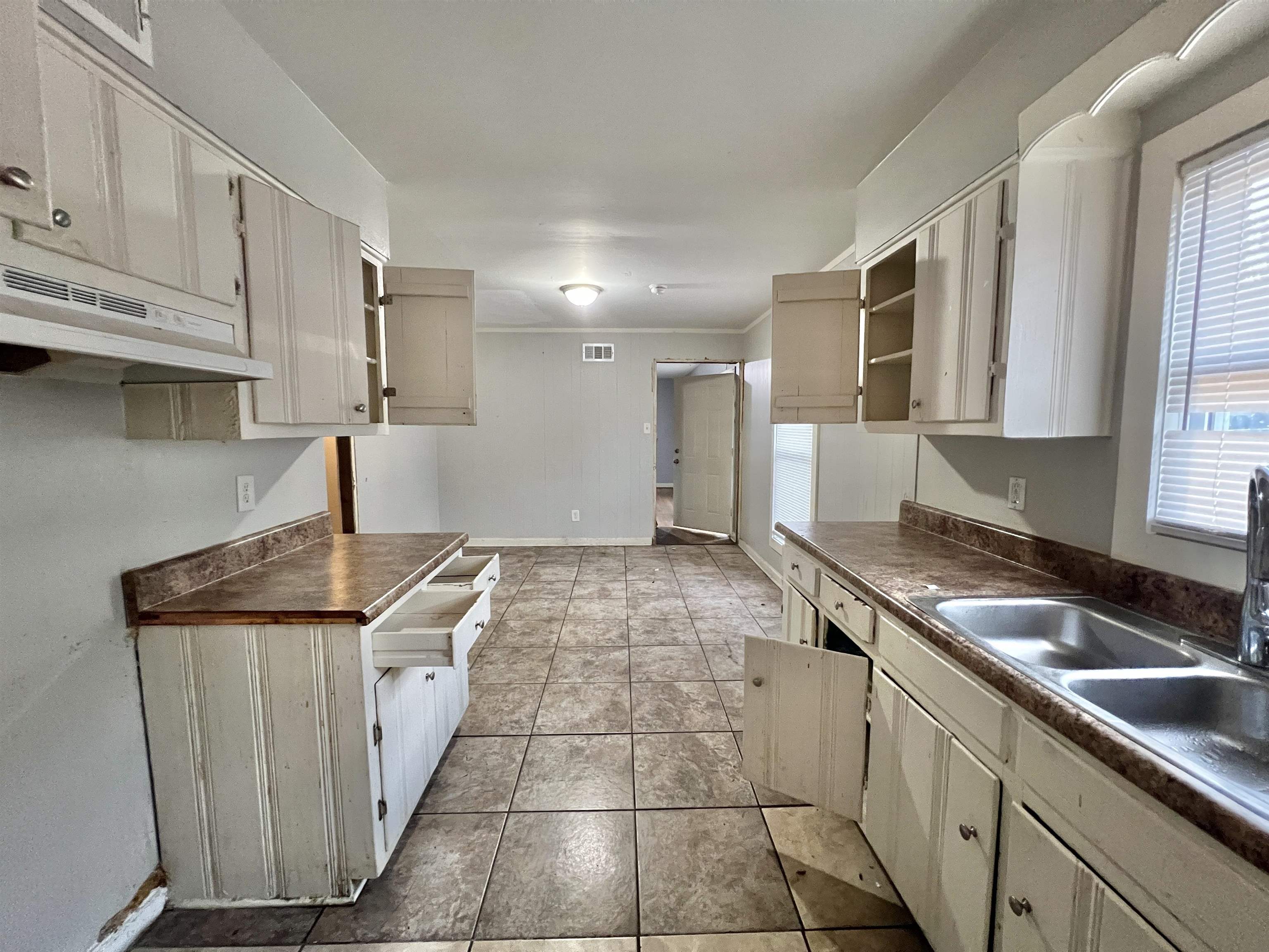 3804 Cazassa Road Memphis, TN 38116 - Photo 5 of 17 Kitchen featuring open shelves, dark countertops, under cabinet range hood, and light tile patterned flooring