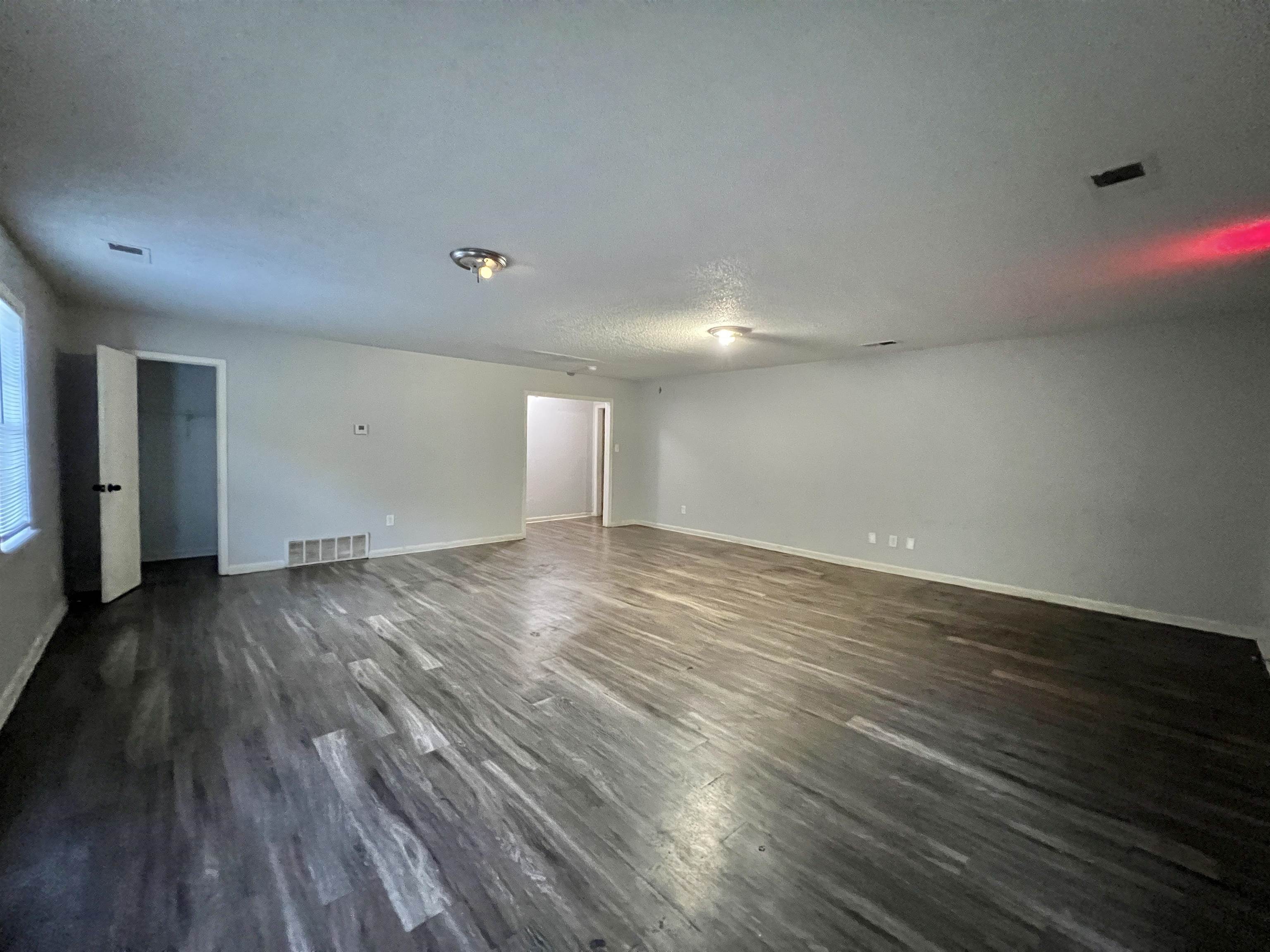 3804 Cazassa Road Memphis, TN 38116 - Photo 10 of 17 Empty room featuring dark wood finished floors and baseboards