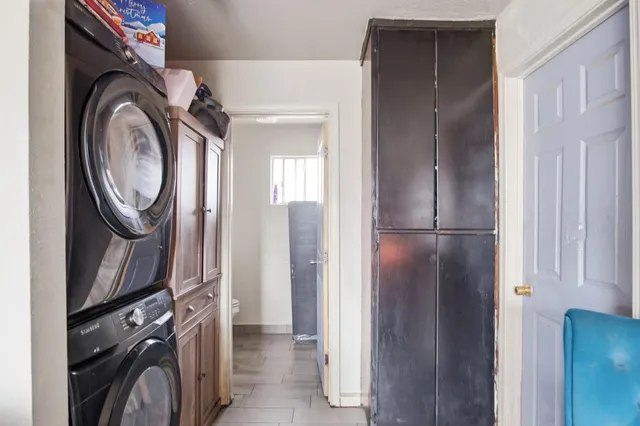 a view of a storage and utility room with dryer and washer