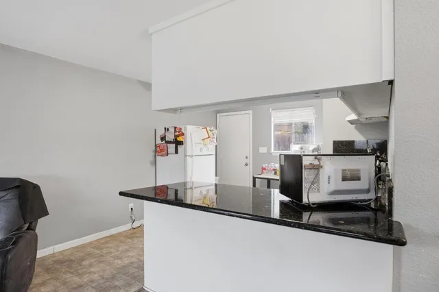 a kitchen with stainless steel appliances granite countertop a sink and a stove