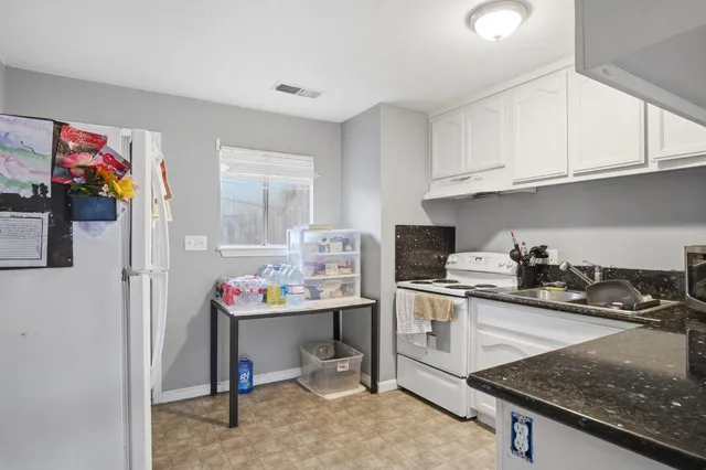 a kitchen that has a sink and a stove in it