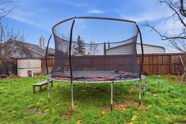 a backyard of a house with table and chairs