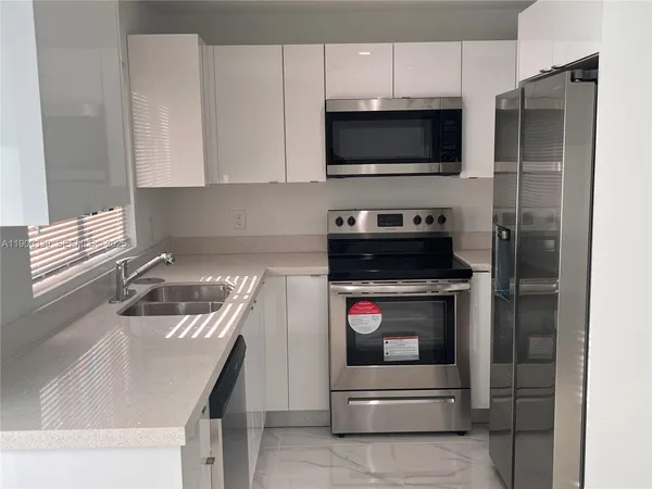a kitchen with a stove and a microwave