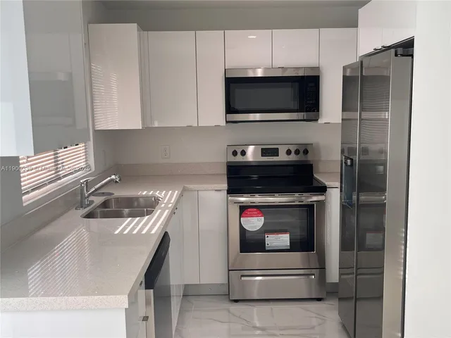 a kitchen with a stove and a microwave