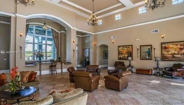 a view of a dining room with furniture large windows and wooden floor