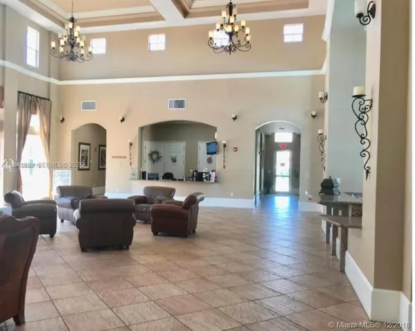 a view of a house with a yard and potted plants