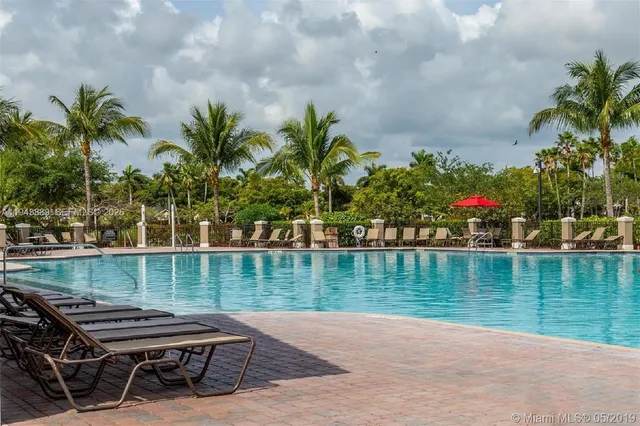 a view of a house with a yard and potted plants