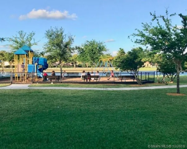 a view of a lake with houses in the back