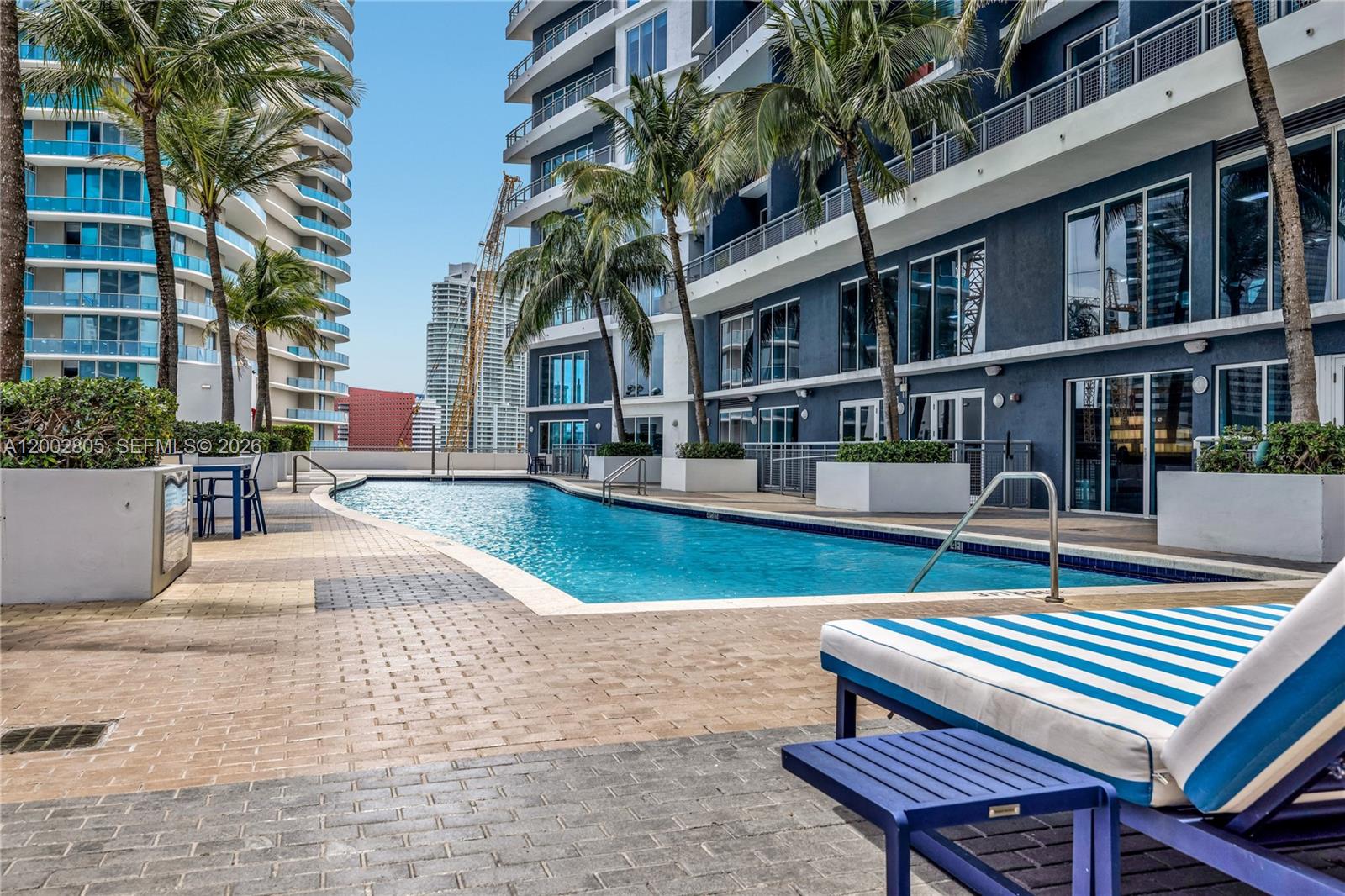 60 Southwest 13th Street, Unit 1124 Miami, FL 33130 - Photo 27 of 30 a swimming pool with outdoor seating and yard