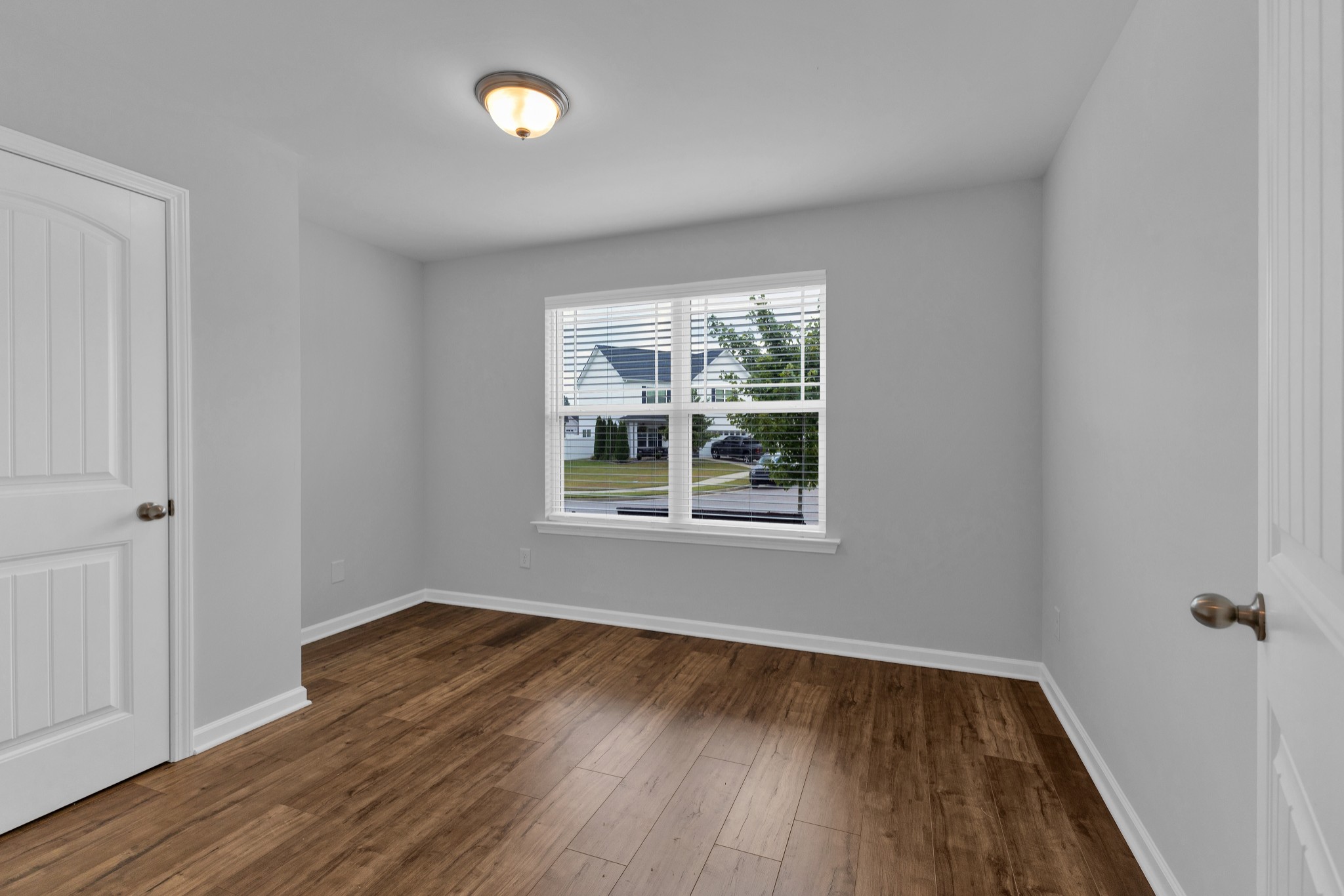 328 Turney Lane Spring Hill, TN 37174 - Photo 21 of 35 a view of an empty room with wooden floor and a window