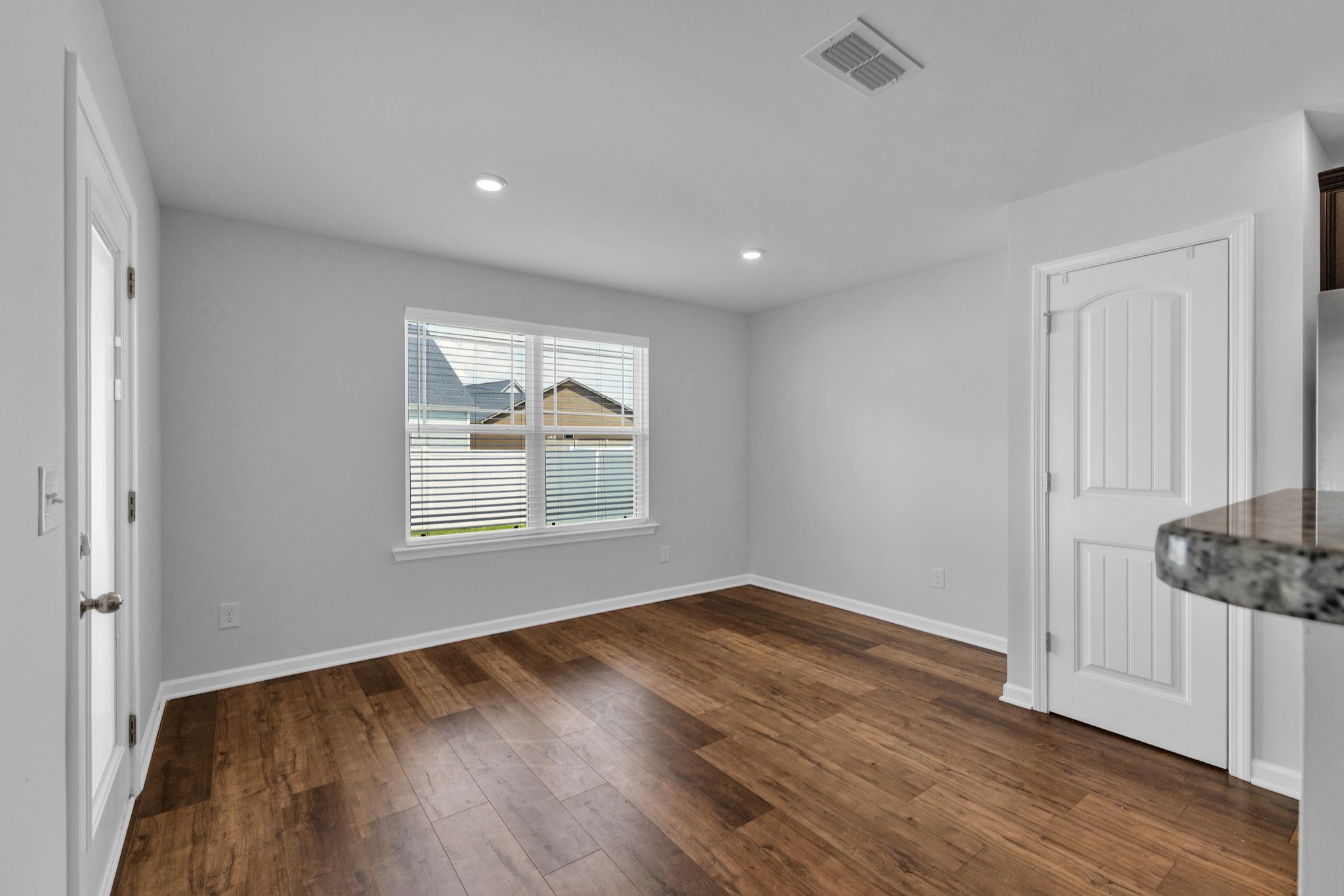 328 Turney Lane Spring Hill, TN 37174 - Photo 10 of 35 a view of an empty room with wooden floor and a window