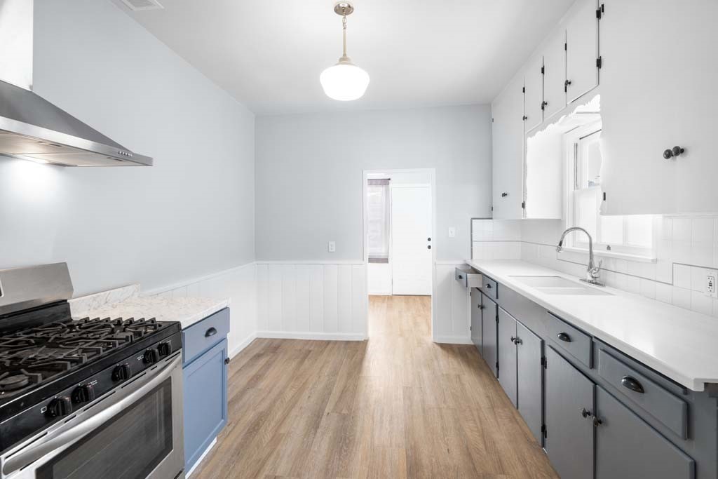 6650 Palm Avenue Riverside, CA 92506 - Photo 11 of 18 a kitchen with granite countertop a sink stove and wooden floor
