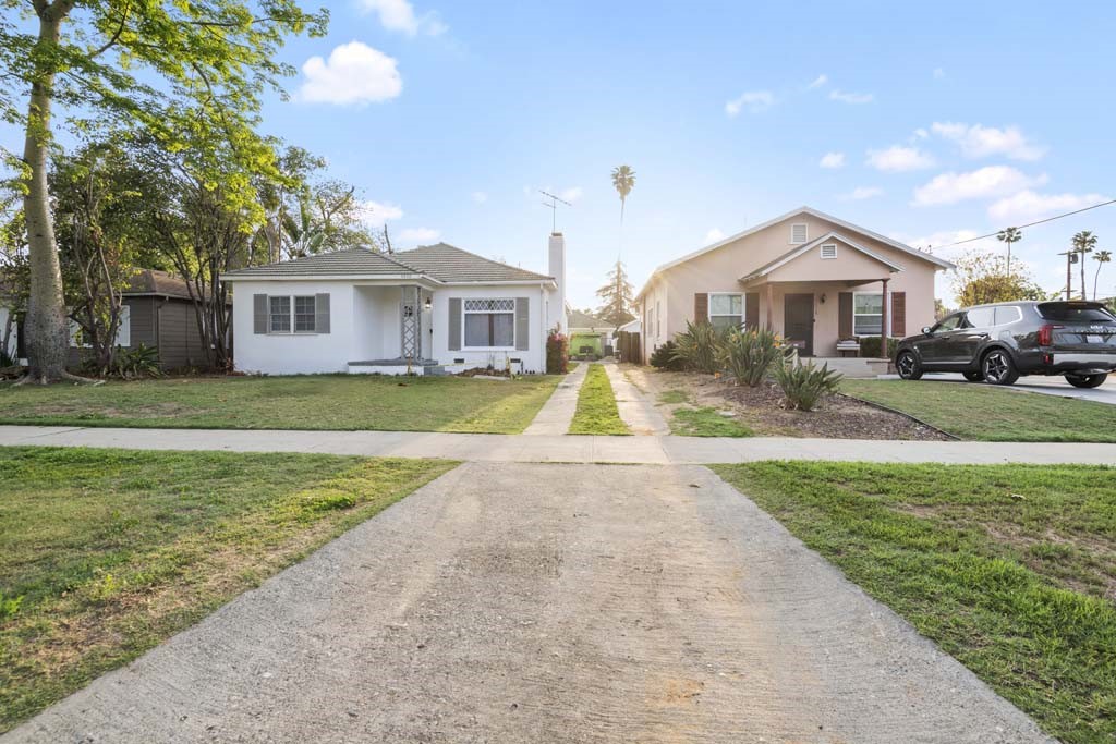 6650 Palm Avenue Riverside, CA 92506 - Photo 3 of 18 a front view of a house with a yard and trees