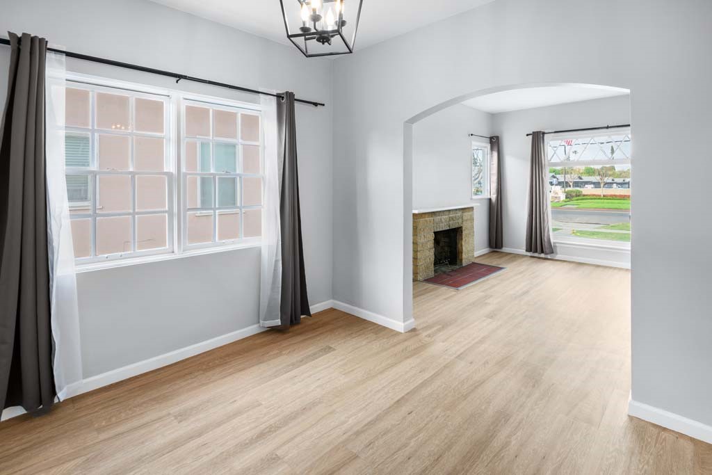 6650 Palm Avenue Riverside, CA 92506 - Photo 6 of 18 an empty room with wooden floor fireplace and windows