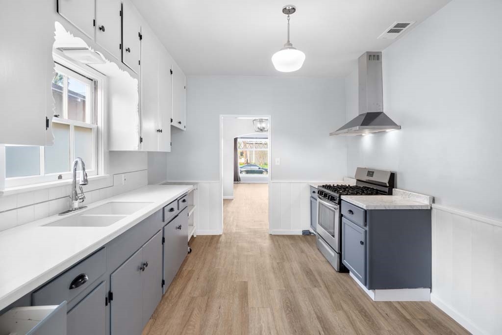 6650 Palm Avenue Riverside, CA 92506 - Photo 10 of 18 a kitchen with a sink stove and cabinets