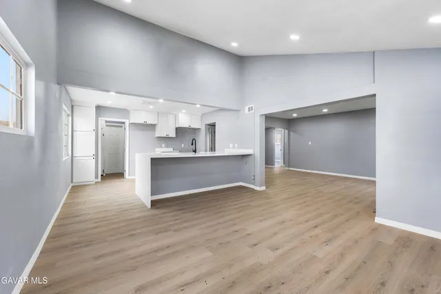a view of a kitchen with a sink and a refrigerator