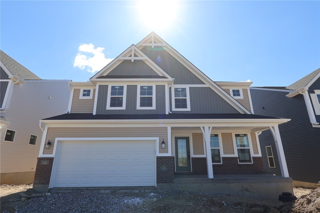 240 Tilly Court, Unit 5 Springboro, OH 45066 - Photo 18 of 26 This newly constructed residence presents a blend of architectural styles, featuring a welcoming porch and attached garage.