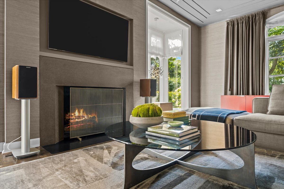 1106 Seneca Road Wilmette, IL 60091 - Photo 17 of 79 a living room with furniture a flat screen tv and a fireplace