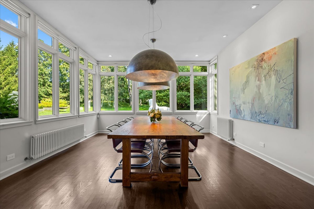 1106 Seneca Road Wilmette, IL 60091 - Photo 23 of 79 a view of a dining room with furniture window and wooden floor
