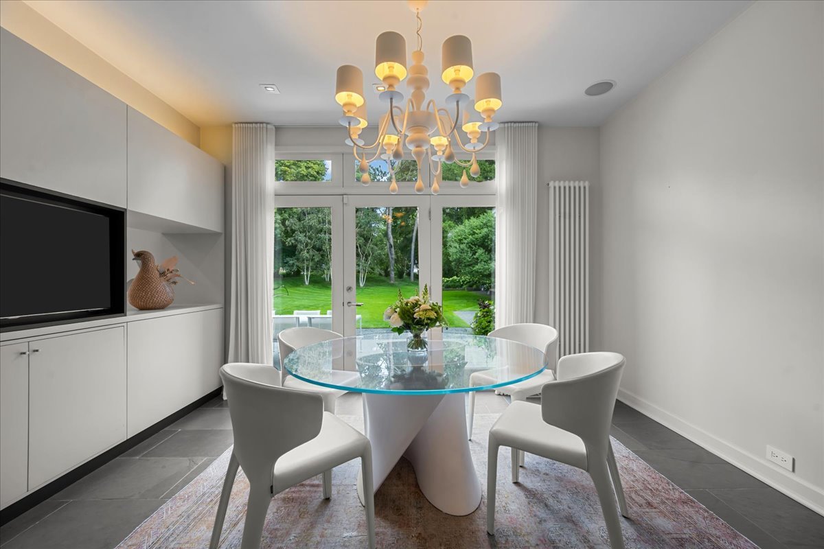 1106 Seneca Road Wilmette, IL 60091 - Photo 29 of 79 a view of a dining room with furniture a chandelier and wooden floor