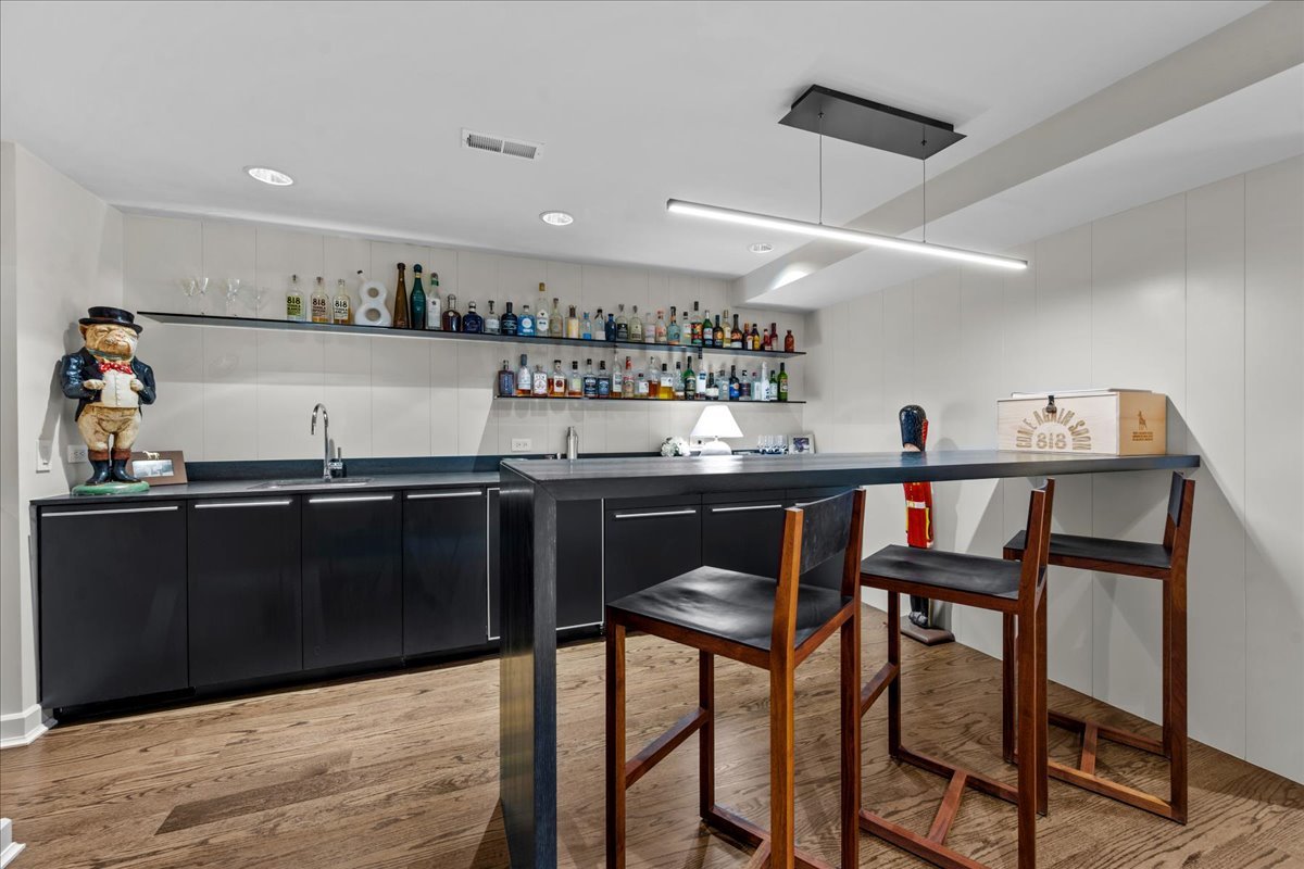 1106 Seneca Road Wilmette, IL 60091 - Photo 61 of 79 a kitchen with stainless steel appliances granite countertop table chairs sink and cabinets