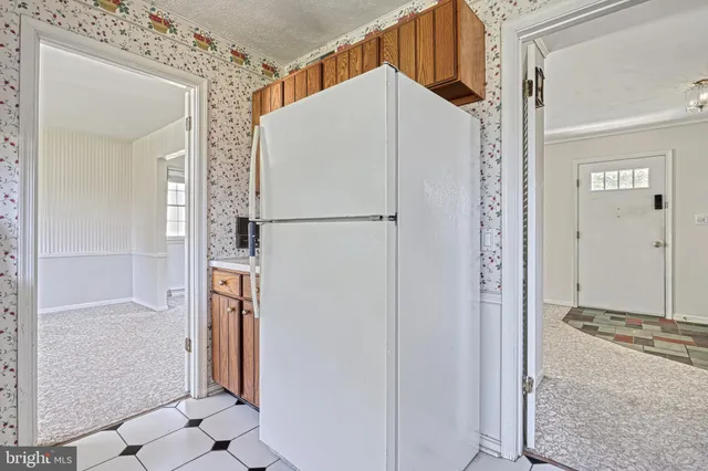 a kitchen with stainless steel appliances a stove a sink a window and dining table