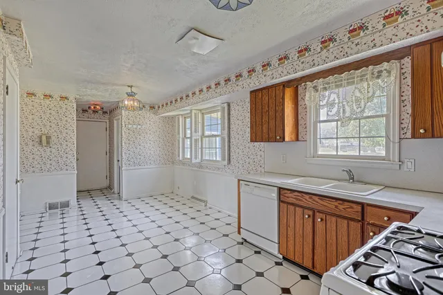 a kitchen with stainless steel appliances a refrigerator sink and cabinets