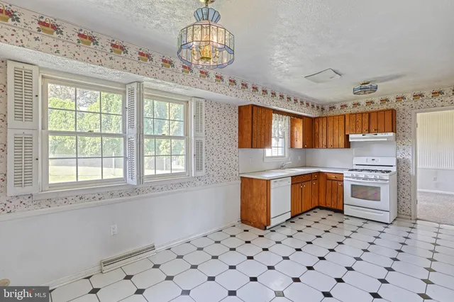a kitchen with stainless steel appliances a stove a sink and a microwave