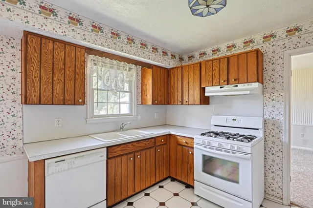 a bathroom with a sink a shower and a mirror