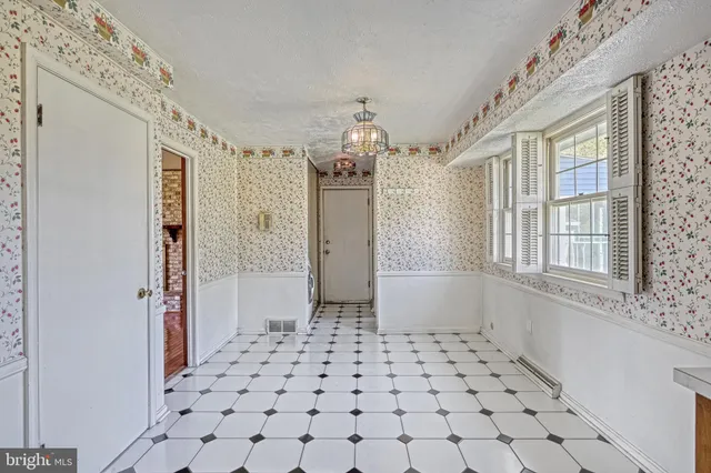 a kitchen with stainless steel appliances a chandelier and a refrigerator
