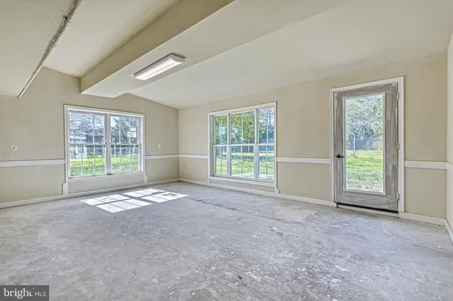 a bathroom with a granite countertop toilet a sink and a mirror