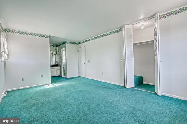 a bathroom with a granite countertop sink a toilet and a mirror