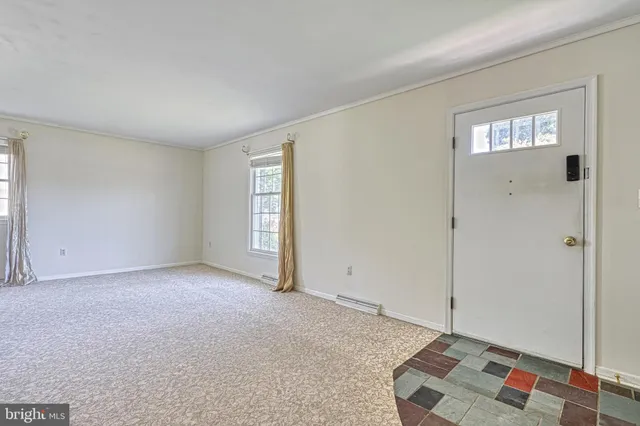 an empty room with windows and closet