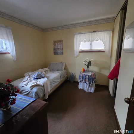 a bedroom with bed and a window