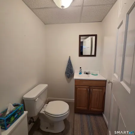 a bathroom with a toilet sink and mirror