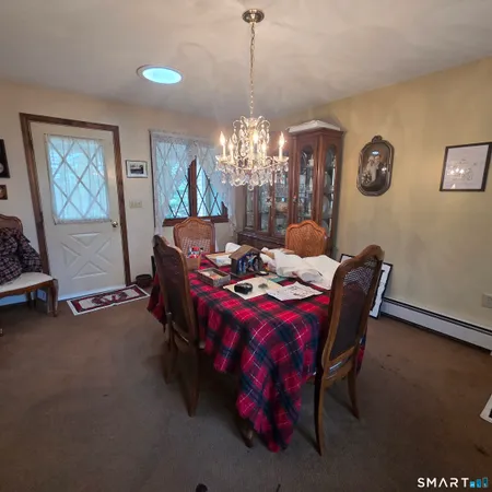 a dining room with furniture and window