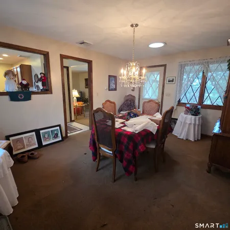 a view of a dining room with furniture and chandelier