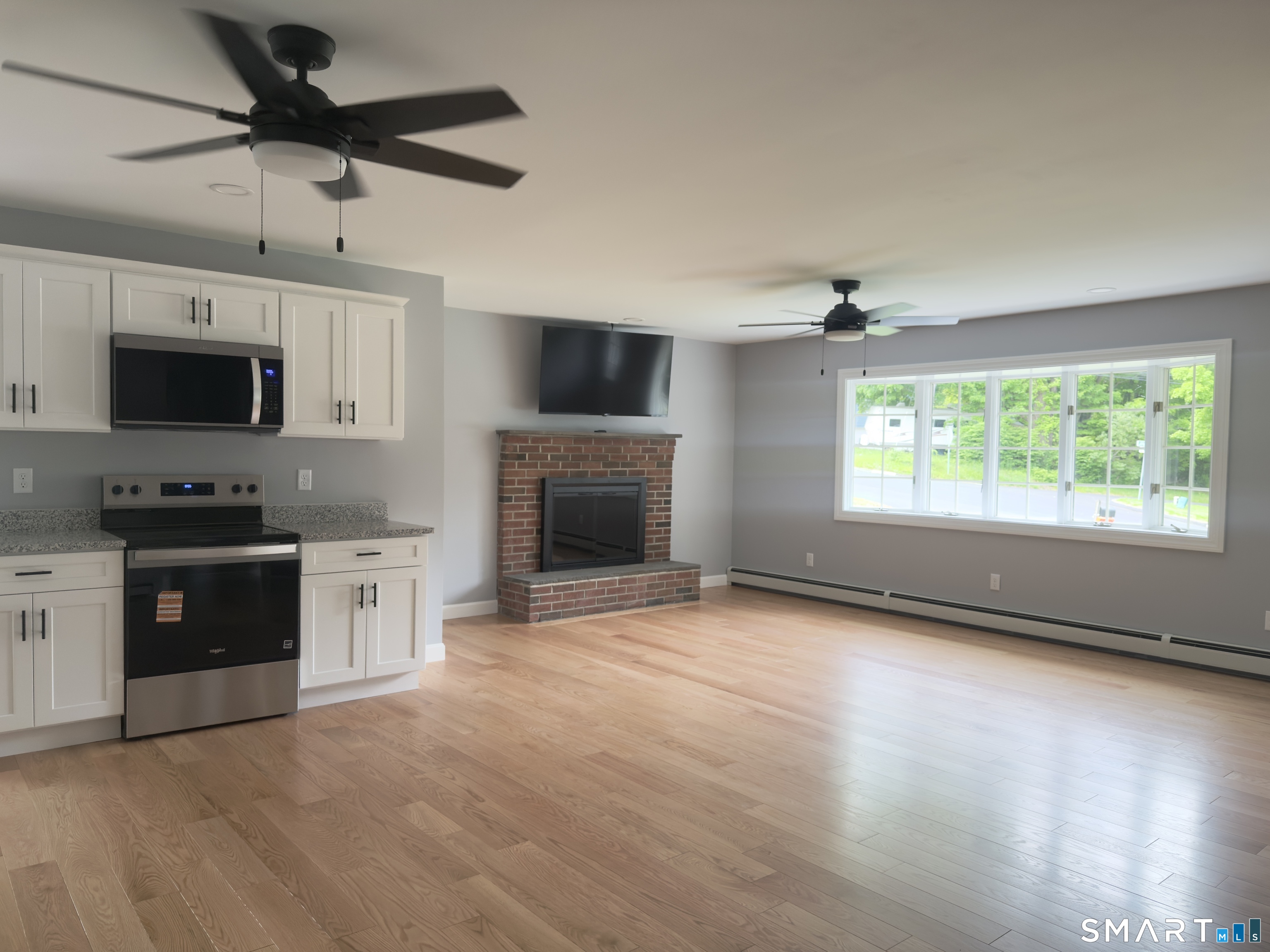 44 Polly Avenue Killingly, CT 06239 - Photo 9 of 22 a view of a kitchen with microwave and stove top oven