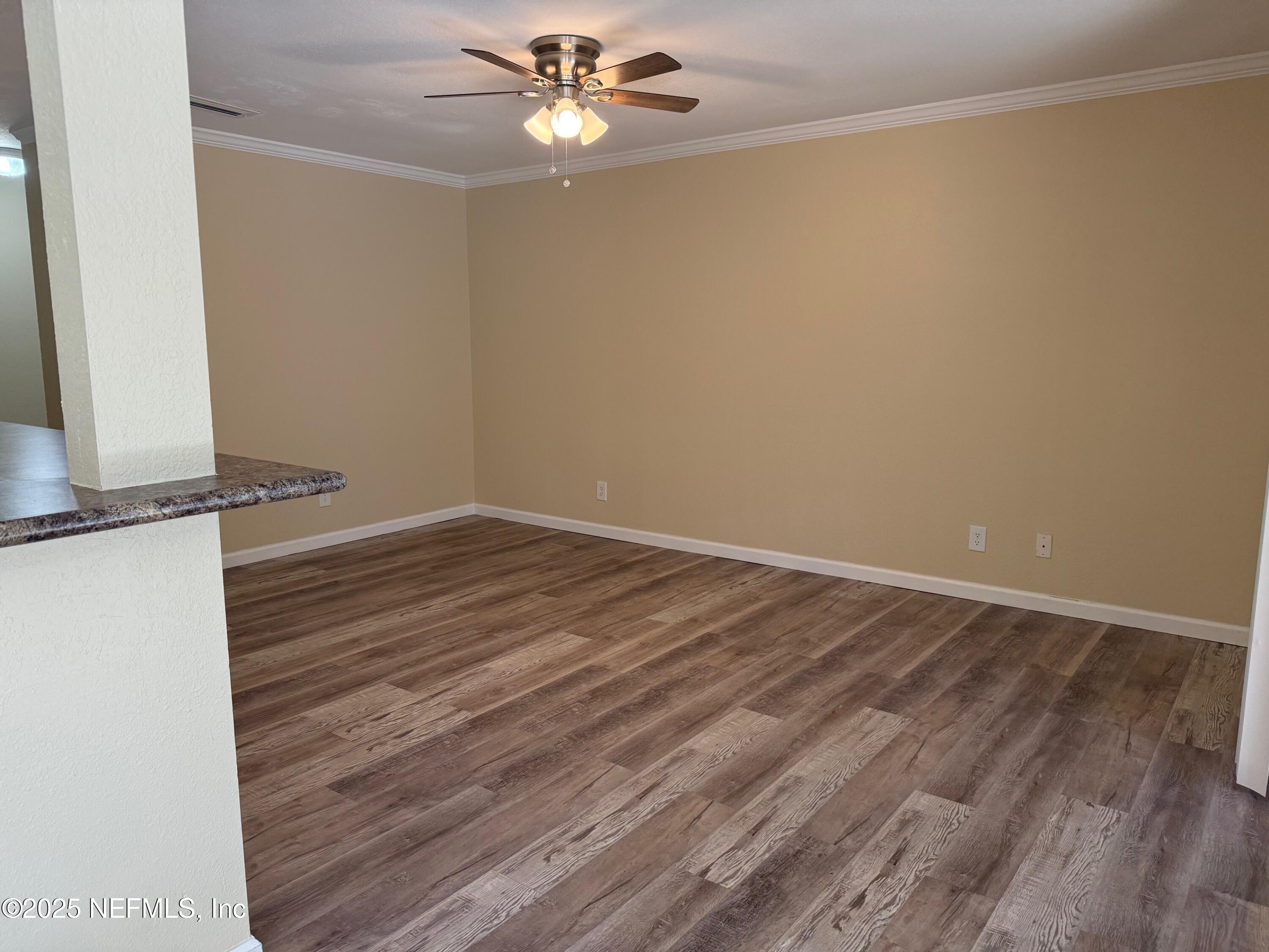 8880 Old Kings Road South, Unit 6 Jacksonville, FL 32257 - Photo 12 of 27 wooden floor in an empty room with a window