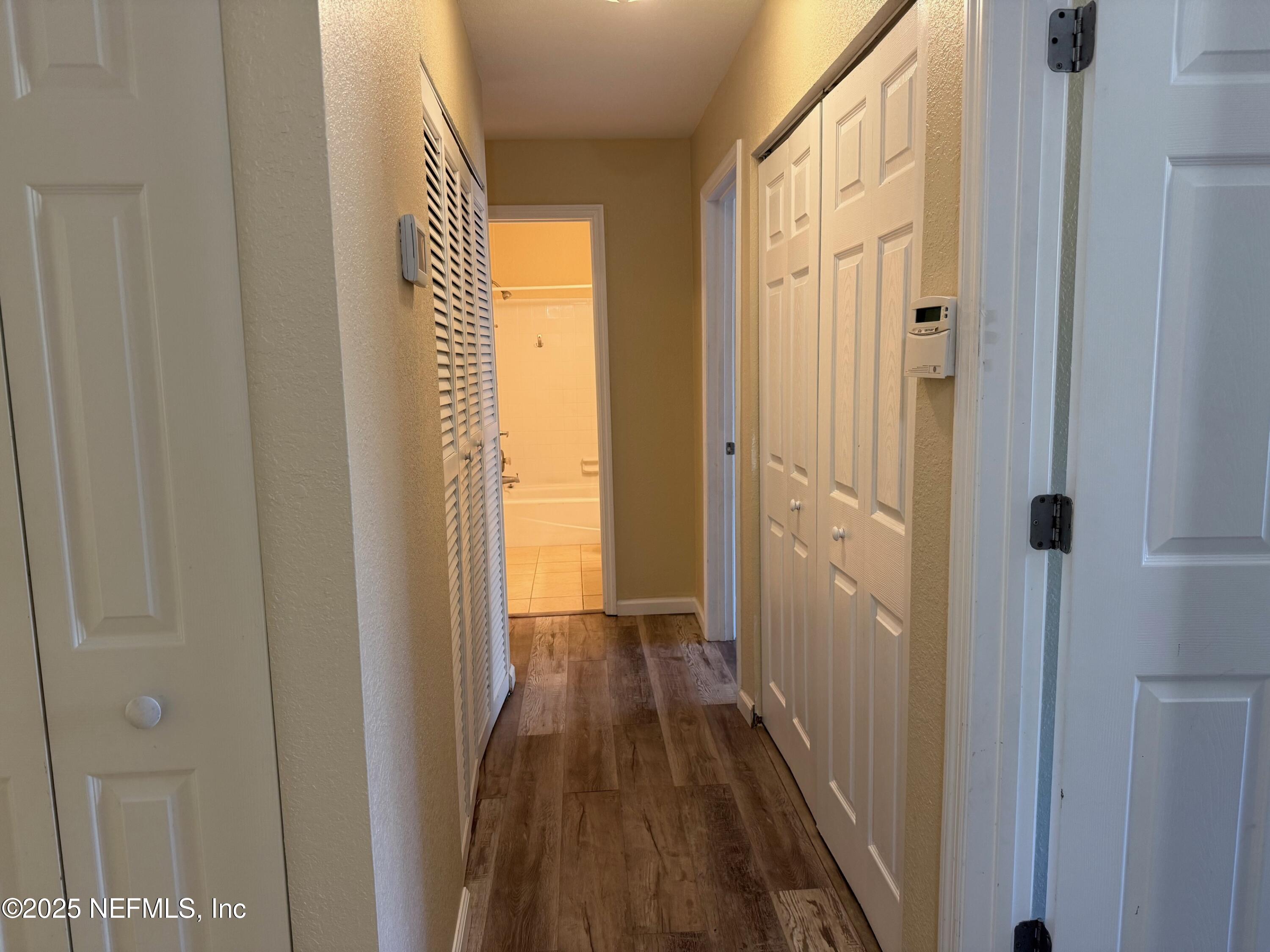 8880 Old Kings Road South, Unit 6 Jacksonville, FL 32257 - Photo 14 of 27 a view of a hallway with wooden floor and a bathroom