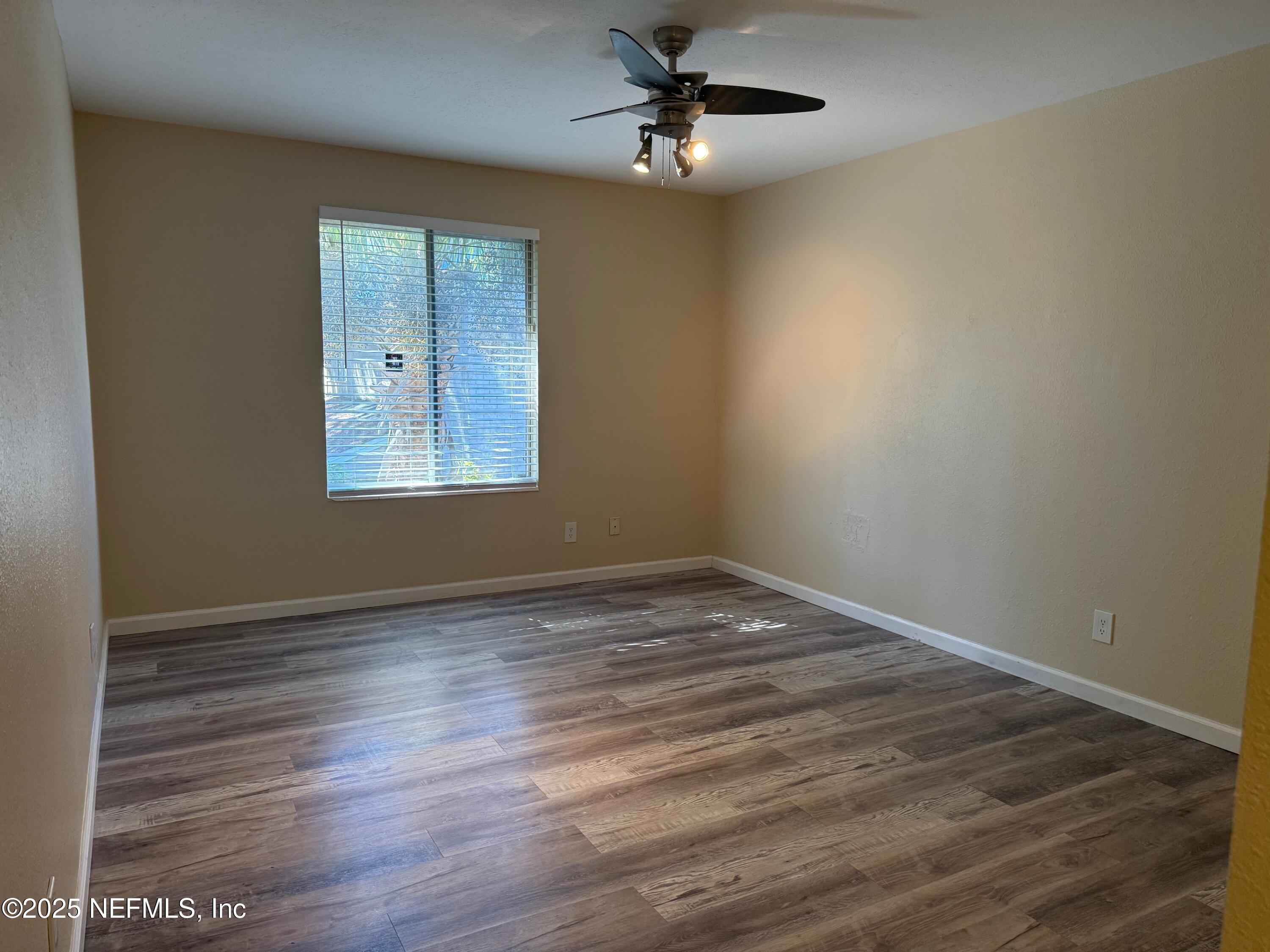 8880 Old Kings Road South, Unit 6 Jacksonville, FL 32257 - Photo 20 of 27 a view of empty room with wooden floor and fan