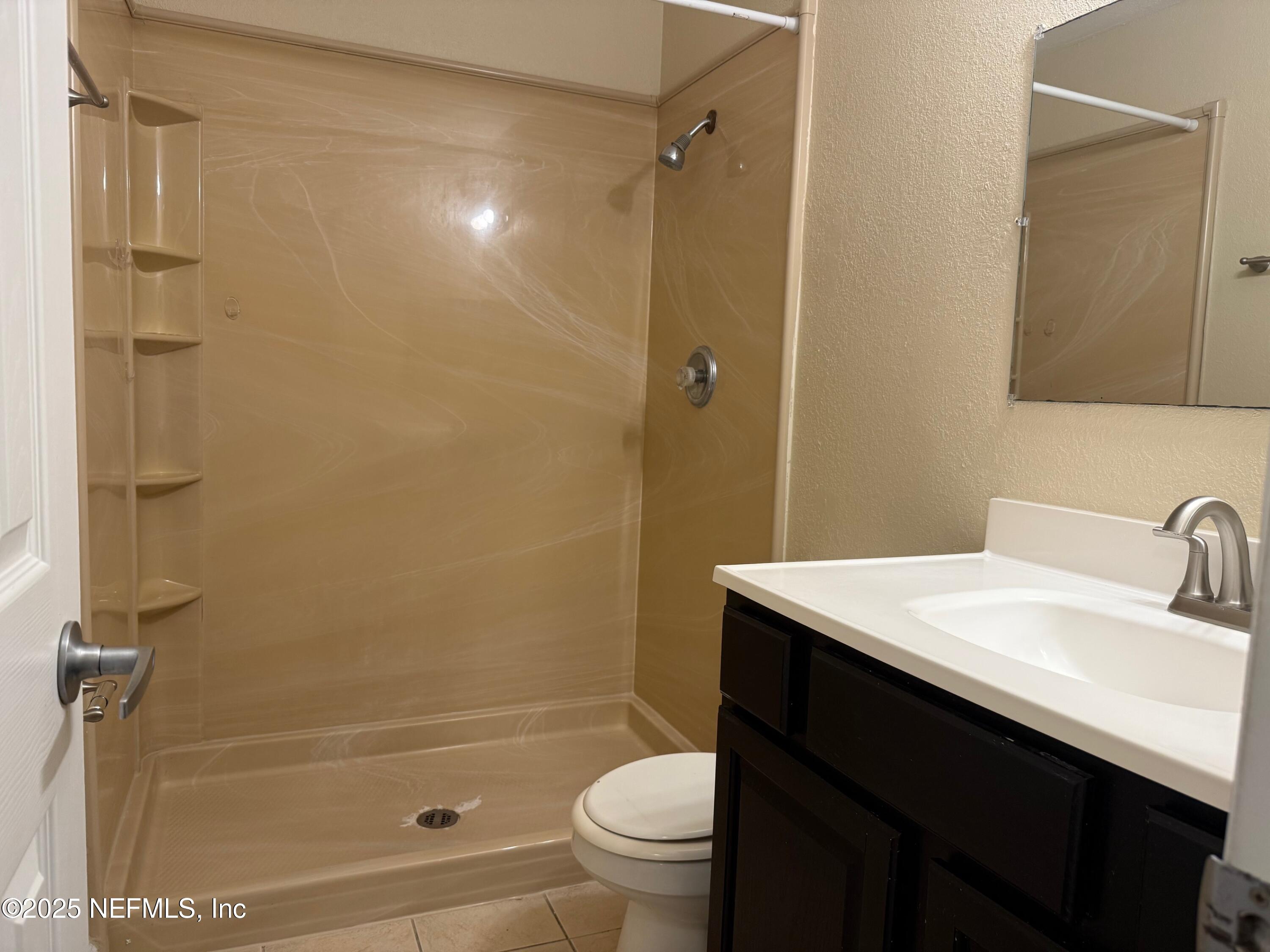 8880 Old Kings Road South, Unit 6 Jacksonville, FL 32257 - Photo 23 of 27 a bathroom with a sink a toilet and shower