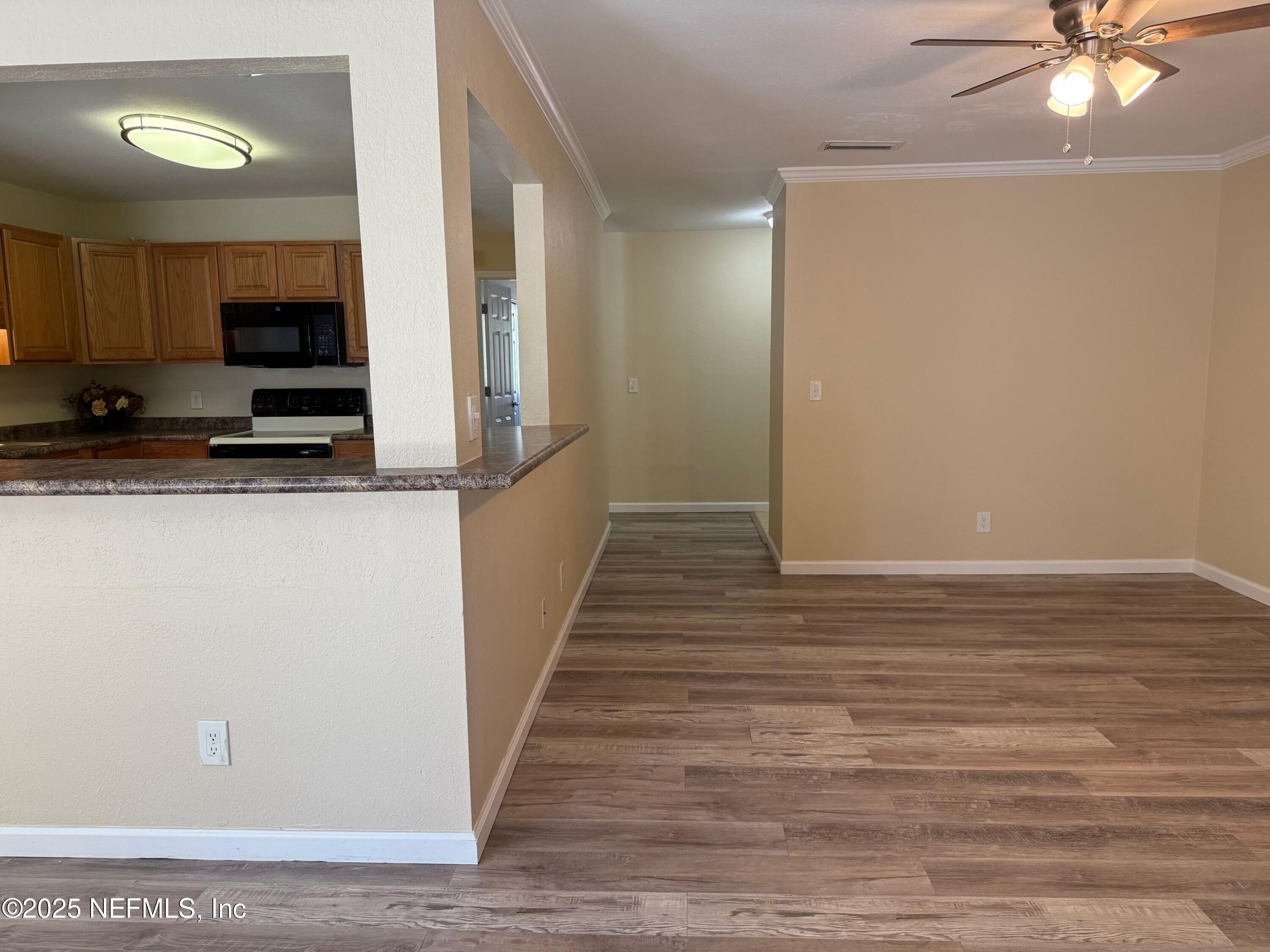 8880 Old Kings Road South, Unit 6 Jacksonville, FL 32257 - Photo 9 of 27 a view of a kitchen cabinets and wooden floor