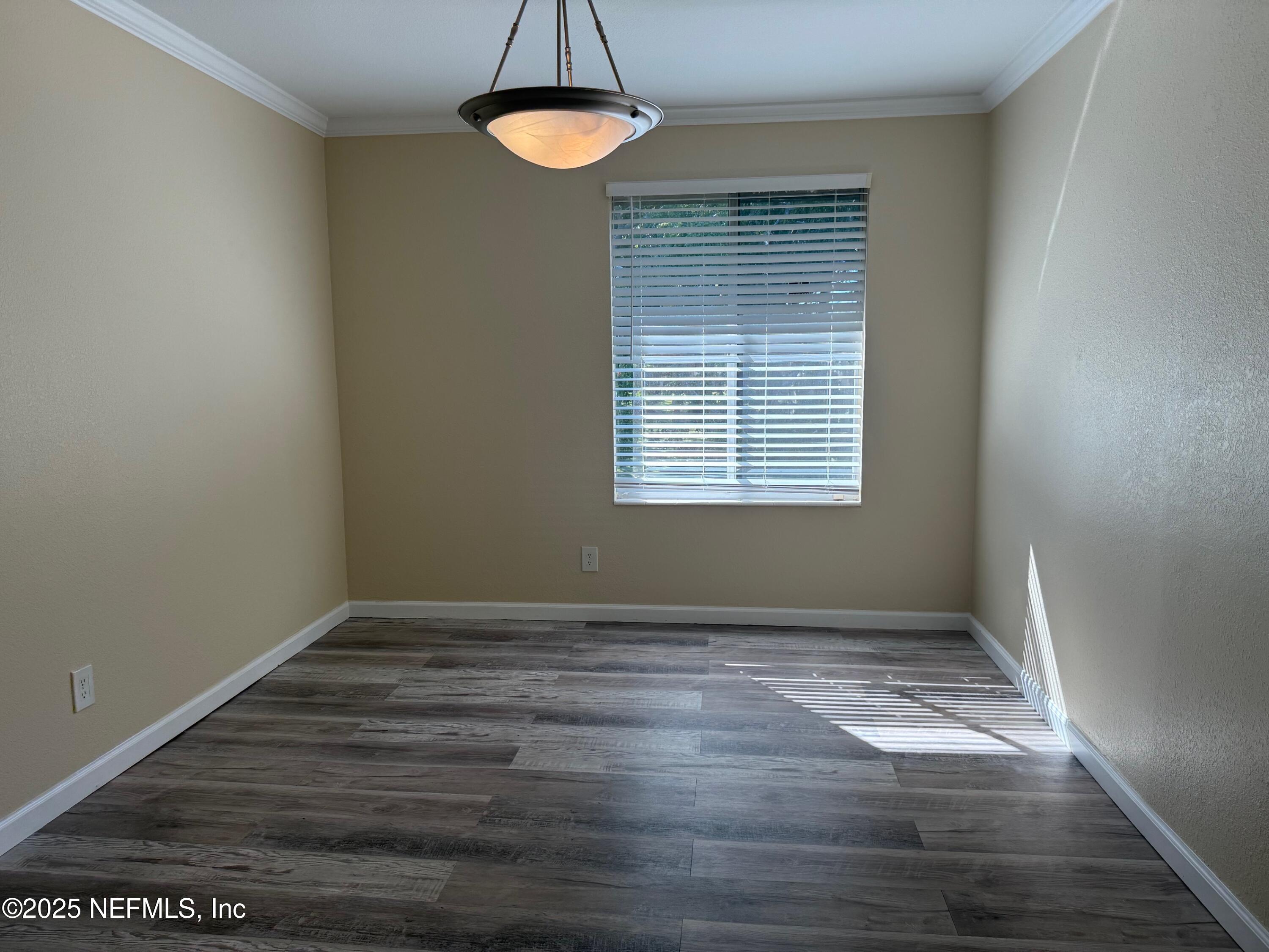 8880 Old Kings Road South, Unit 6 Jacksonville, FL 32257 - Photo 10 of 27 a view of an empty room with wooden floor and a window
