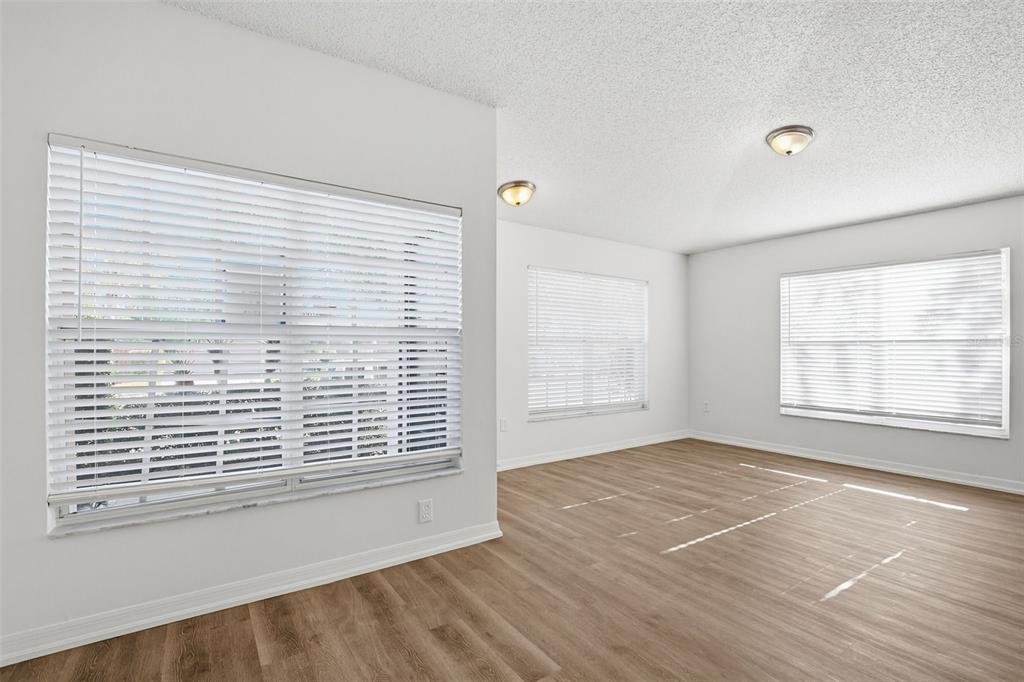 305 Abigail Road Plant City, FL 33563 - Photo 14 of 37 a view of an empty room with wooden floor and a window