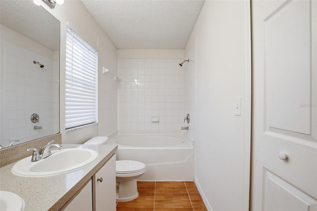 305 Abigail Road Plant City, FL 33563 - Photo 31 of 37 a bathroom with a sink a toilet and shower
