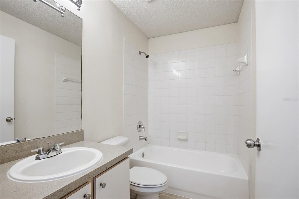 305 Abigail Road Plant City, FL 33563 - Photo 32 of 37 a bathroom with a sink a toilet and a bathtub