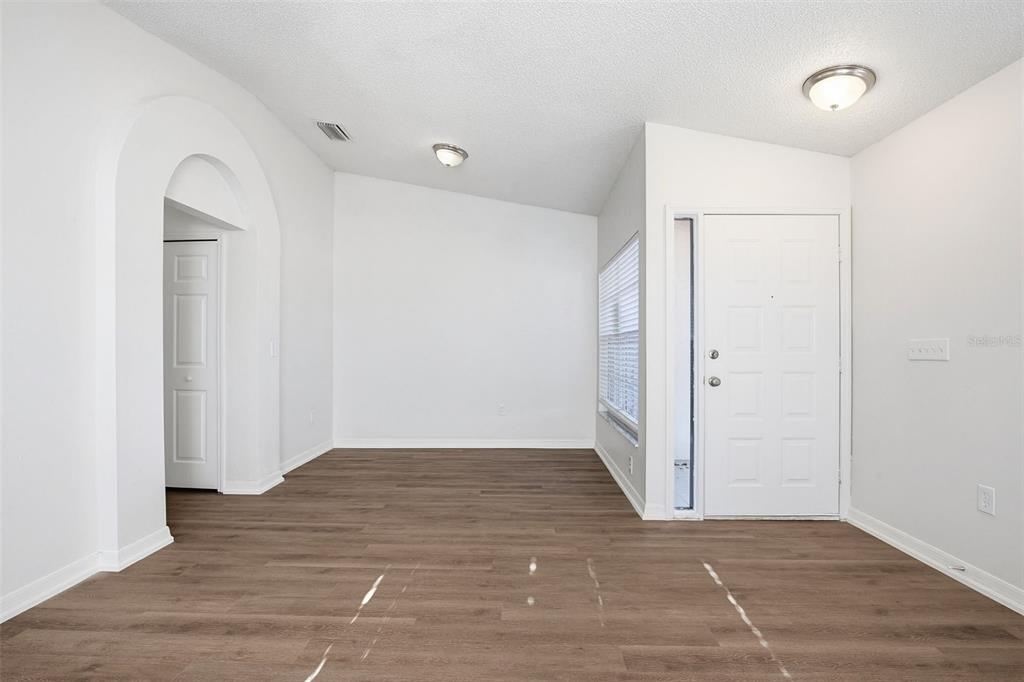 305 Abigail Road Plant City, FL 33563 - Photo 7 of 37 an empty room with wooden floor