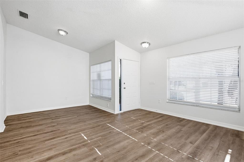 305 Abigail Road Plant City, FL 33563 - Photo 8 of 37 a view of an empty room with wooden floor and a window