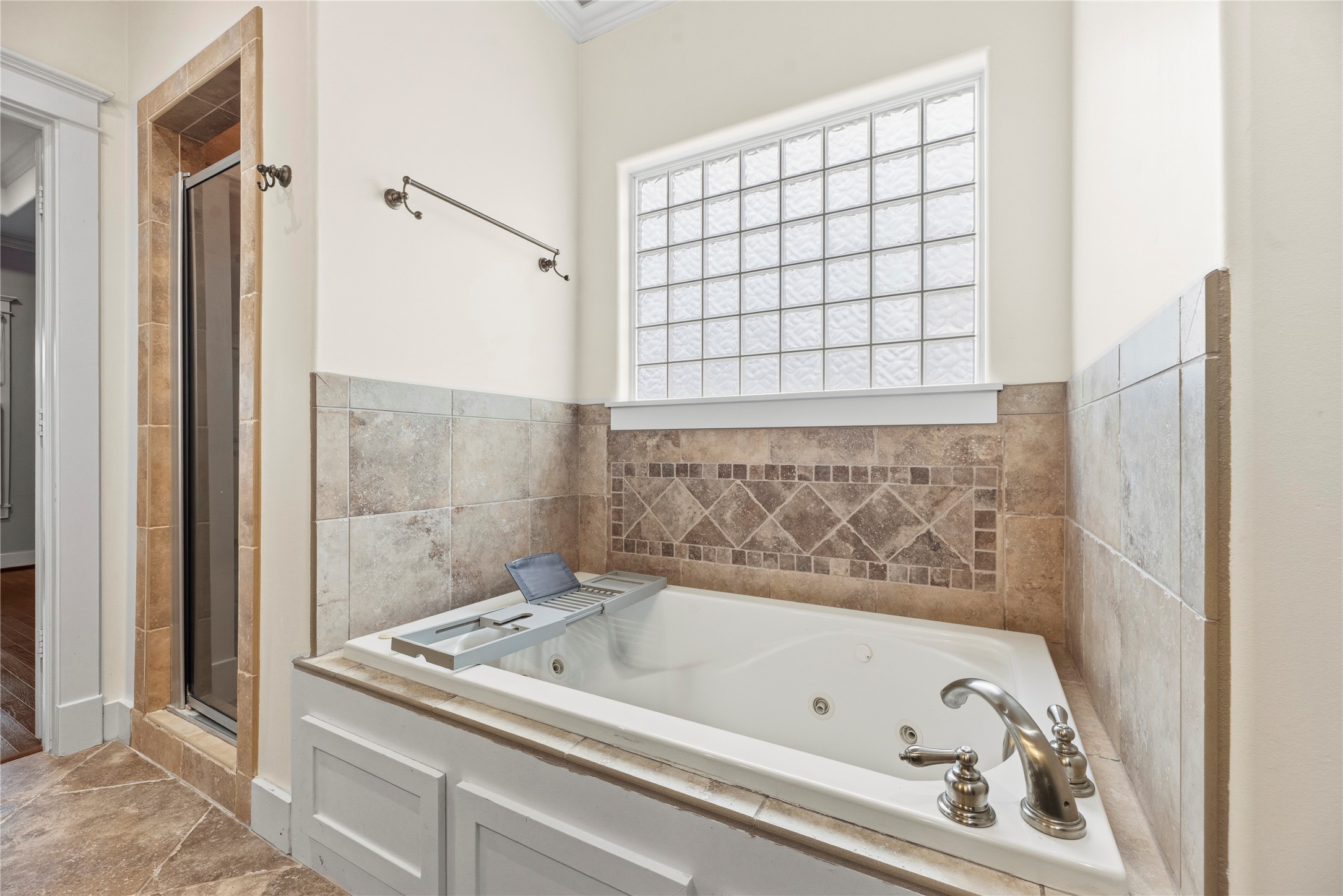 1505 Prince Street Houston, TX 77008 - Photo 24 of 39 Luxurious tub with natural light from the window, and a separate walk-in shower — all with timeless tile work and handy hardware.